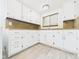 A bright laundry room features white cabinets and modern appliances at 907 S A St, Elwood, IN 46036