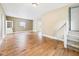 Bright living room featuring hardwood floors, neutral walls, and staircase at 907 S A St, Elwood, IN 46036