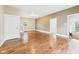 Bright living room featuring hardwood floors, neutral walls, and an open doorway to porch at 907 S A St, Elwood, IN 46036