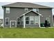 A spacious backyard featuring a well-maintained lawn and the rear exterior of the home with many windows at 9133 Thames Dr, Avon, IN 46123
