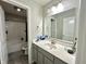 Clean bathroom with a single vanity, a large mirror, and tub with shower at 9133 Thames Dr, Avon, IN 46123
