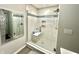 Updated shower with a glass door, tiled walls, and a built-in shelf at 9133 Thames Dr, Avon, IN 46123