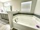 Bright bathroom with a large soaking tub and tile accents at 9133 Thames Dr, Avon, IN 46123