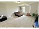 Comfortable bedroom features a brown futon, large window, and neutral carpet flooring at 9133 Thames Dr, Avon, IN 46123