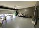 A large garage features an open door, painted flooring, and ample space for storage or projects at 9133 Thames Dr, Avon, IN 46123