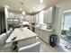 Spacious kitchen with gray cabinets, granite counters, island with bar seating, and stainless appliances at 9133 Thames Dr, Avon, IN 46123