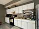 The kitchen features modern appliances, light cabinetry, and a striking tile backsplash at 9133 Thames Dr, Avon, IN 46123