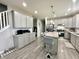 Modern kitchen with sleek gray cabinets, stainless steel appliances, and an island with seating at 9133 Thames Dr, Avon, IN 46123