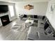 Cozy living room with gray sectional, fireplace, and large windows for ample natural light at 9133 Thames Dr, Avon, IN 46123