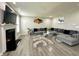 Bright living room features a plush gray sectional sofa, a modern fireplace, and stylish artwork at 9133 Thames Dr, Avon, IN 46123