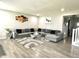 Spacious living room with large sectional sofa, stylish decor, and modern flooring at 9133 Thames Dr, Avon, IN 46123