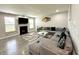 Inviting living room boasts a cozy fireplace, plush gray sofa, and modern decor at 9133 Thames Dr, Avon, IN 46123