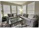 Bright living room with two gray sofas, natural light, and modern decor accents at 9133 Thames Dr, Avon, IN 46123