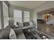 Inviting living room with comfortable gray sofas, large windows, and cozy decor at 9133 Thames Dr, Avon, IN 46123