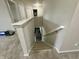 Well-lit staircase with carpeted steps and white railings leads to the upper level of the home at 9133 Thames Dr, Avon, IN 46123