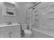 Modern bathroom with matching shower and vanity featuring gray walls and a shower with decorative shower curtain at 9317 E 36Th Pl, Indianapolis, IN 46235
