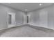 Neutral bedroom features carpet, gray walls, and white doors leading to an adjacent bathroom and hallway at 9317 E 36Th Pl, Indianapolis, IN 46235