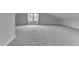 An attic bedroom features neutral walls, carpet, and window at 9317 E 36Th Pl, Indianapolis, IN 46235