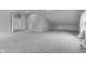 An attic bedroom features neutral walls, carpet, and window and hallway at 9317 E 36Th Pl, Indianapolis, IN 46235
