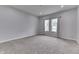 Spacious bedroom features neutral carpet, gray walls, and double windows that provide lots of natural light at 9317 E 36Th Pl, Indianapolis, IN 46235