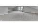 An attic bedroom features neutral walls, carpet, and window at 9317 E 36Th Pl, Indianapolis, IN 46235