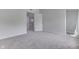 An attic bedroom features neutral walls, carpet, window, and a door at 9317 E 36Th Pl, Indianapolis, IN 46235
