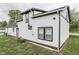 Side view of two-story white home with black accents at 9317 E 36Th Pl, Indianapolis, IN 46235