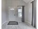 Bright foyer featuring tile floors, a window with curtains, and a white front door at 9317 E 36Th Pl, Indianapolis, IN 46235
