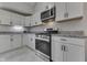 Modern kitchen with white cabinets, granite countertops, and stainless steel appliances at 9317 E 36Th Pl, Indianapolis, IN 46235