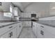 Bright kitchen featuring white cabinets, granite countertops, modern appliances, and ample counter space at 9317 E 36Th Pl, Indianapolis, IN 46235