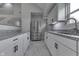 Contemporary kitchen with white cabinets, granite countertops, and stainless steel refrigerator at 9317 E 36Th Pl, Indianapolis, IN 46235