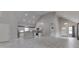 Spacious living room flowing into the kitchen, featuring high ceilings and modern lighting fixtures at 9317 E 36Th Pl, Indianapolis, IN 46235