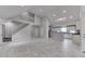 Open-concept living room with high ceilings, staircase, and seamless flow into a modern kitchen at 9317 E 36Th Pl, Indianapolis, IN 46235