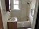 Modest bathroom design including sink, toilet, and shower-tub combination with window above bathtub at 1020 E 30Th St, Anderson, IN 46016