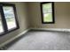 Carpeted bedroom with two windows offering plenty of natural light at 1020 E 30Th St, Anderson, IN 46016