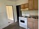 Kitchen features gas range and double basin sink, with view to another room at 1020 E 30Th St, Anderson, IN 46016