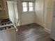 Bright kitchen features gas range, double basin sink, and view to exterior stairs at 1020 E 30Th St, Anderson, IN 46016