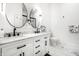 Bathroom featuring dual sinks, marble countertops, and modern black hardware at 1034 N Tacoma Ave, Indianapolis, IN 46201