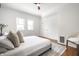 Light and airy bedroom with warm hardwood floors, white walls, and two large windows at 1034 N Tacoma Ave, Indianapolis, IN 46201