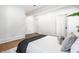 Bedroom featuring hardwood floors, a large bed, and crisp white paint at 1034 N Tacoma Ave, Indianapolis, IN 46201
