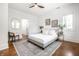 Bright bedroom featuring a ceiling fan, a neutral color palette, and hardwood floors at 1034 N Tacoma Ave, Indianapolis, IN 46201