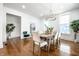 Well-lit dining room featuring hardwood floors and an elegant chandelier at 1034 N Tacoma Ave, Indianapolis, IN 46201