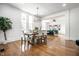 Open-concept dining room with hardwood floors and a view into the living room at 1034 N Tacoma Ave, Indianapolis, IN 46201