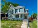Inviting home exterior featuring a covered front porch, blue siding, and well-manicured landscaping at 1034 N Tacoma Ave, Indianapolis, IN 46201