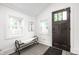 Foyer with a bench, decorative art, tiled floor, and a wood door with glass inserts at 1034 N Tacoma Ave, Indianapolis, IN 46201