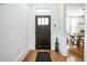 Bright foyer with hardwood floors and stylish front door, leading to dining area at 1034 N Tacoma Ave, Indianapolis, IN 46201