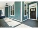 Inviting covered porch featuring painted blue wood planking and a decorative ceiling fan at 1034 N Tacoma Ave, Indianapolis, IN 46201