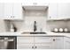 Bright kitchen features a modern faucet, herringbone tile backsplash, and quartz countertops at 1034 N Tacoma Ave, Indianapolis, IN 46201