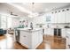 Bright kitchen with an island, modern appliances, hardwood floors, and an open floor plan at 1034 N Tacoma Ave, Indianapolis, IN 46201