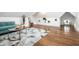 Bright living room with geometric rug, light blue sofa, hardwood floors, and modern decor at 1034 N Tacoma Ave, Indianapolis, IN 46201